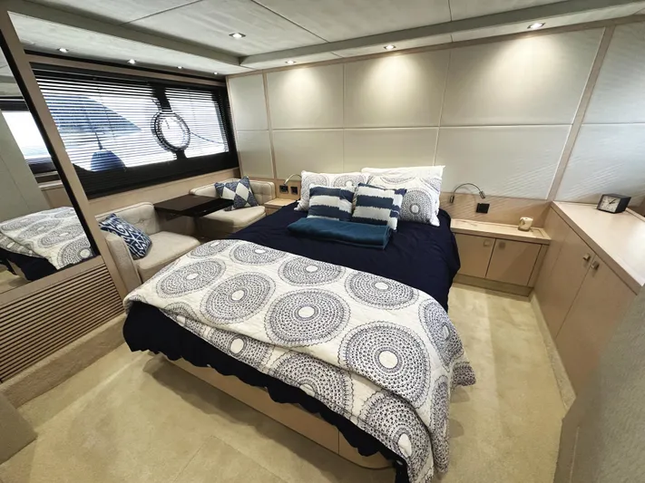 Tucker II Yacht Photos Pics Luxurious bedroom interior of 2015 Sunseeker Predator 57 yacht, featuring elegant bedding and modern design.