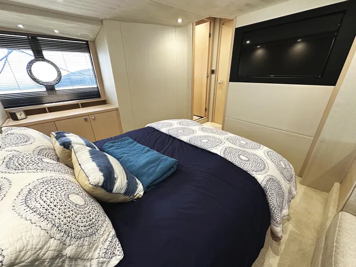 Tucker II Yacht Photos Pics Luxurious bedroom interior of 2015 Sunseeker Predator 57 yacht with modern decor and large TV.