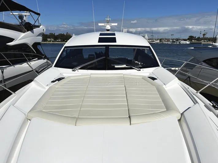 Tucker II Yacht Photos Pics 2015 Sunseeker Predator 57 yacht with spacious sunbathing deck, docked at marina.