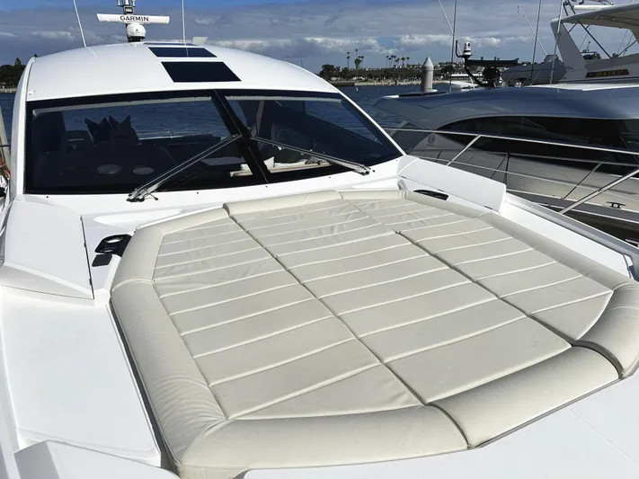 Tucker II Yacht Photos Pics 2015 Sunseeker Predator 57 yacht with spacious sunbathing deck, docked at marina.