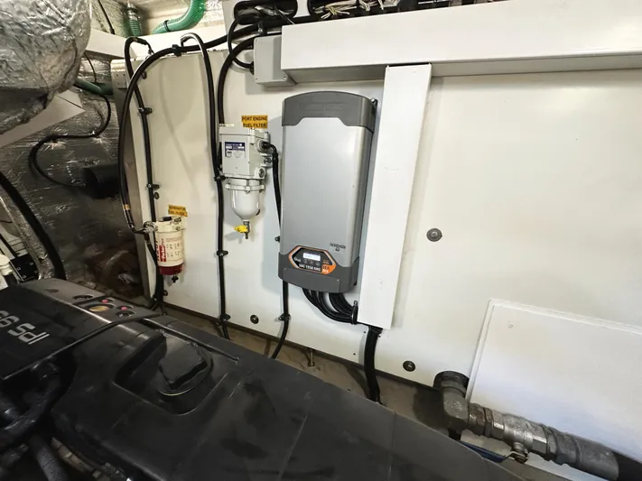 Tucker II Yacht Photos Pics Engine room of 2015 Sunseeker Predator 57 yacht, showcasing mechanical components and wiring.