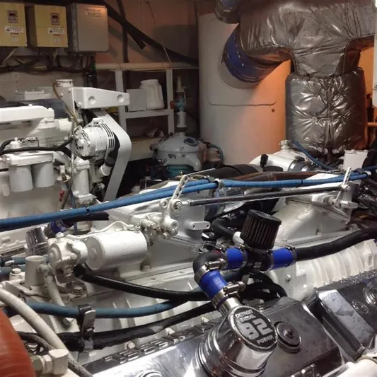 Audacity Yacht Photos Pics Engine room of 1990 Broward Raised Pilothouse MY yacht, showcasing mechanical components and piping.