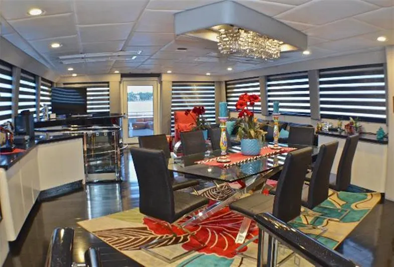 Audacity Yacht Photos Pics Luxurious dining area on 1990 Broward Raised Pilothouse MY yacht with modern decor and vibrant accents.