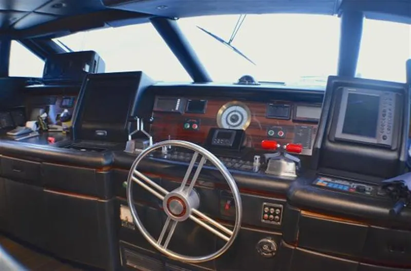 Audacity Yacht Photos Pics Pilothouse interior of 1990 Broward Raised Pilothouse MY yacht, featuring navigation equipment and steering wheel.