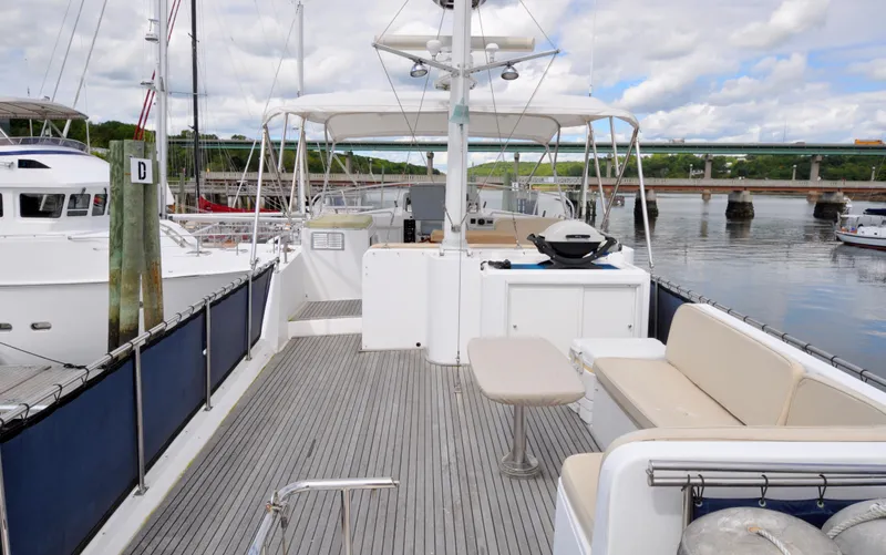  Yacht Photos Pics Grand Banks Heritage Europa 52 yacht deck, 2000 model, docked at a marina with scenic views.