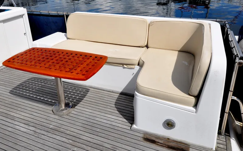  Yacht Photos Pics Outdoor seating area on a 2000 Grand Banks Heritage Europa 52 yacht with a wooden table.