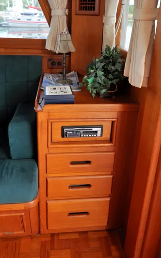  Yacht Photos Pics Interior of 2000 Grand Banks Heritage Europa 52 with wooden cabinetry and green upholstery.