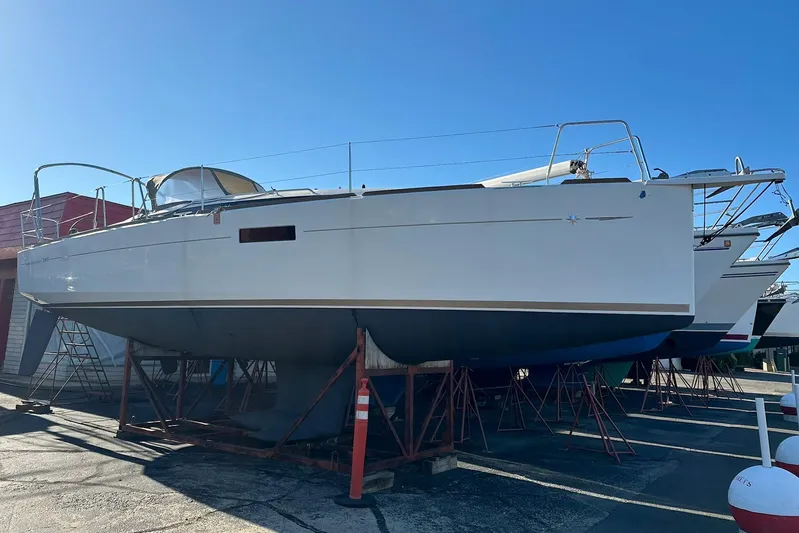  Yacht Photos Pics 2020 Jeanneau Sun Odyssey 349 sailboat on dry dock, side view.