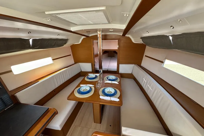  Yacht Photos Pics Interior of 2020 Jeanneau Sun Odyssey 349 yacht with elegant dining area setup.