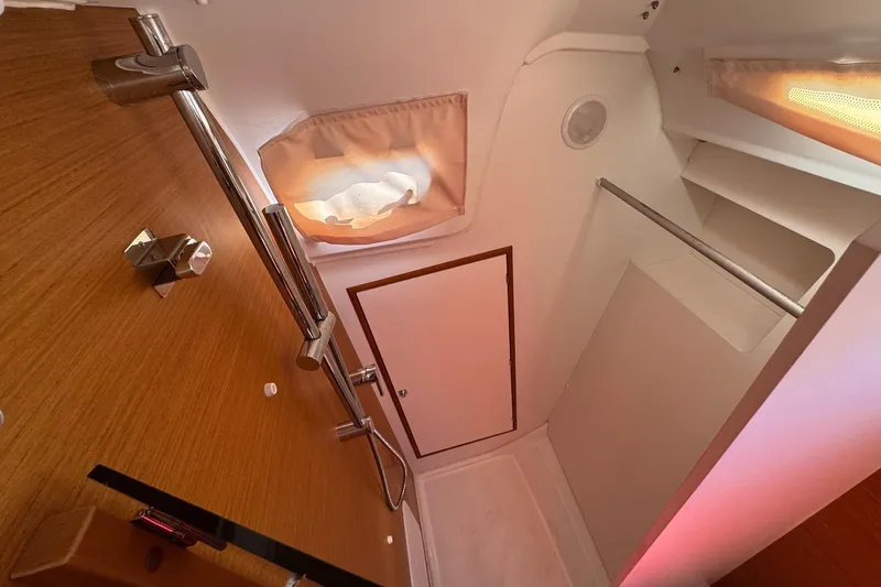  Yacht Photos Pics Interior of 2020 Jeanneau Sun Odyssey 349 yacht bathroom with wooden accents and modern fixtures.