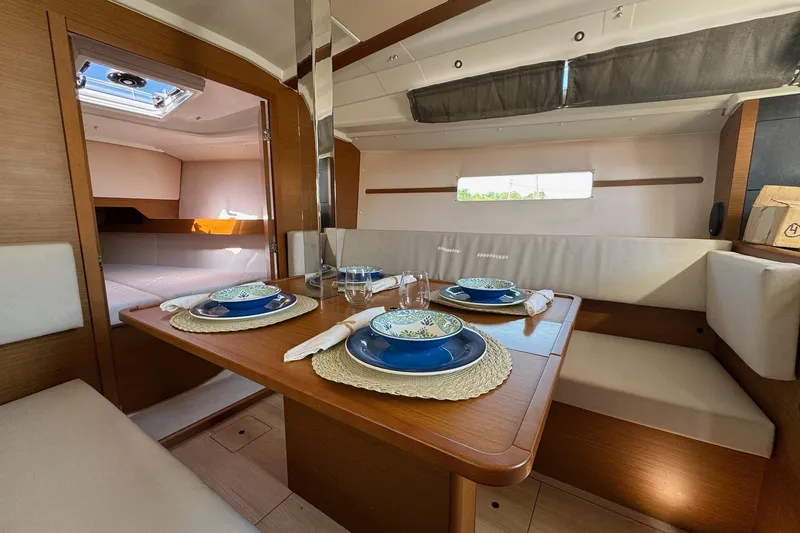  Yacht Photos Pics Interior of 2020 Jeanneau Sun Odyssey 349 yacht with elegant dining setup.