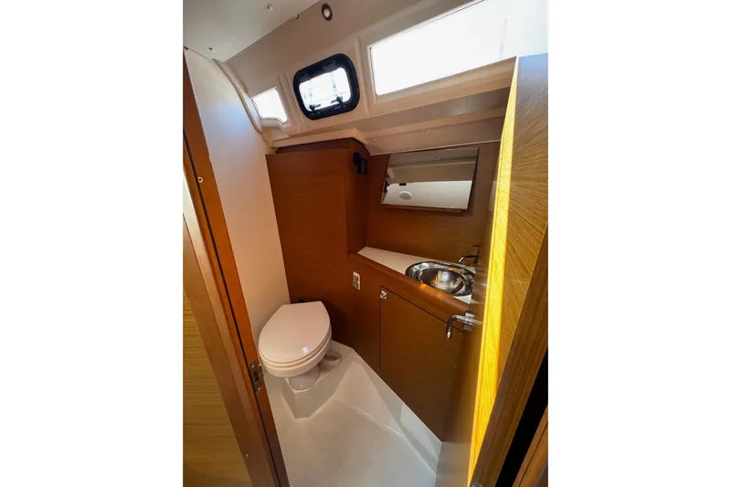  Yacht Photos Pics Modern bathroom in 2020 Jeanneau Sun Odyssey 349 yacht, featuring toilet and sink.