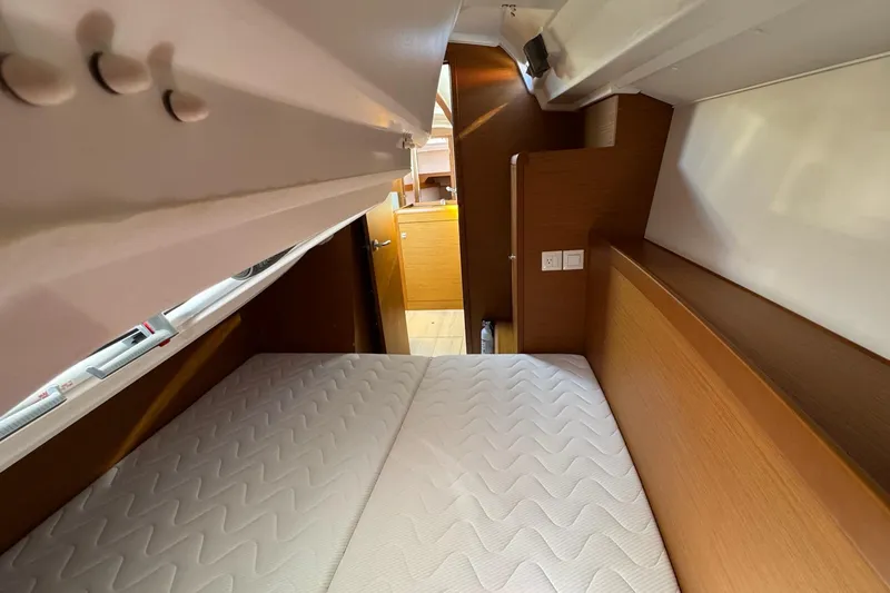  Yacht Photos Pics Cozy cabin interior of 2020 Jeanneau Sun Odyssey 349 sailboat with comfortable bedding.