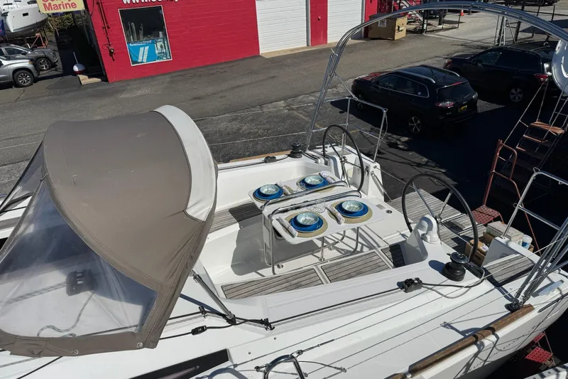  Yacht Photos Pics 2020 Jeanneau Sun Odyssey 349 sailboat with covered cockpit, docked at a marina.