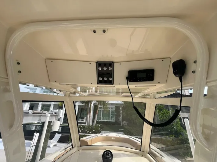 Outnumbered Yacht Photos Pics 2020 Scout 277LXF boat interior with control panel and radio equipment.