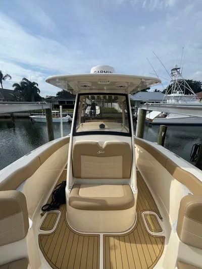 Outnumbered Yacht Photos Pics 2020 Scout 277LXF boat with tan seating, docked at a marina.