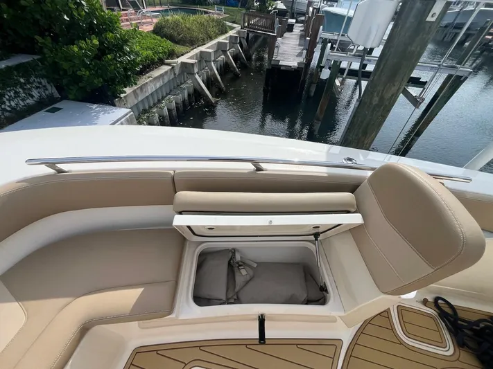 Outnumbered Yacht Photos Pics 2020 Scout 277LXF boat interior with open storage compartment, dockside view.