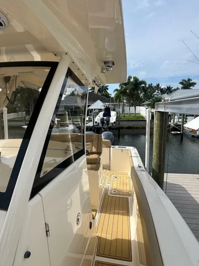 Outnumbered Yacht Photos Pics 2020 Scout 277LXF boat docked, featuring sleek design and spacious deck.