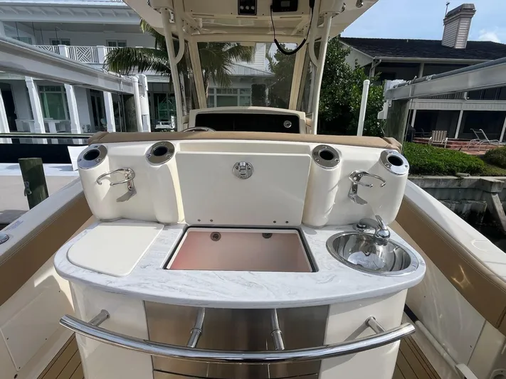 Outnumbered Yacht Photos Pics 2020 Scout 277LXF boat interior with sink and storage compartments.