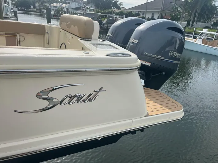 Outnumbered Yacht Photos Pics 2020 Scout 277LXF boat with twin Yamaha 200 engines docked by the water.