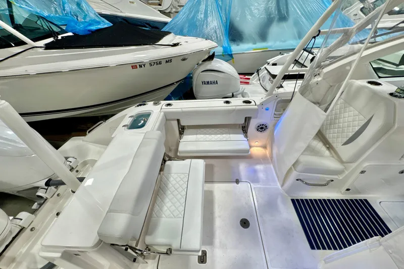  Yacht Photos Pics 2024 Pursuit DC 266 Dual Console boat interior with Yamaha engine, featuring white seating and modern design.