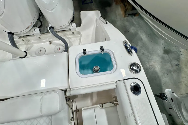  Yacht Photos Pics 2024 Pursuit DC 266 Dual Console boat interior with livewell and seating area.