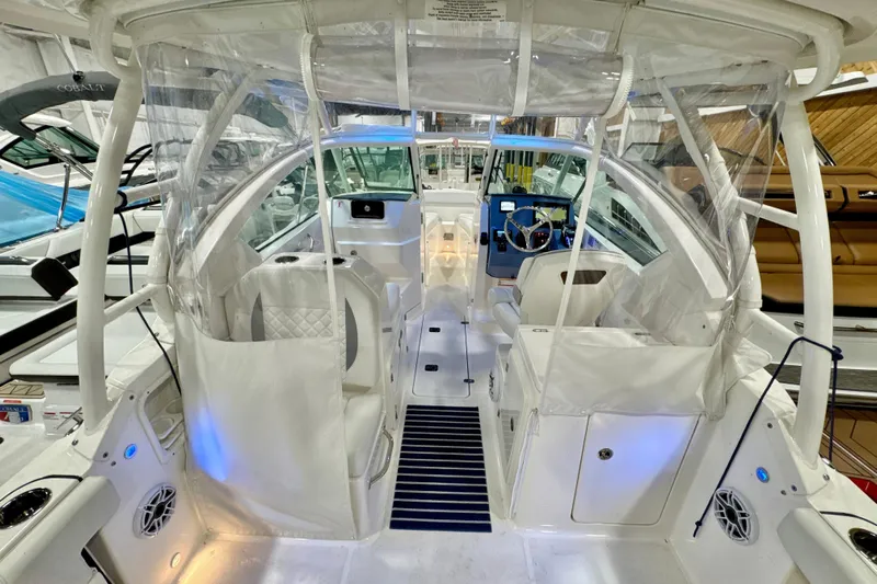  Yacht Photos Pics 2024 Pursuit DC 266 Dual Console boat interior with modern seating and steering area.