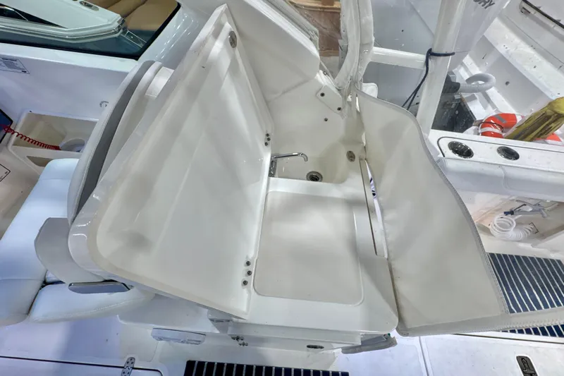  Yacht Photos Pics 2024 Pursuit DC 266 Dual Console boat interior with foldable seating and storage.