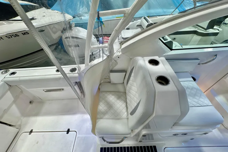  Yacht Photos Pics 2024 Pursuit DC 266 Dual Console boat interior with white seating and cup holders.