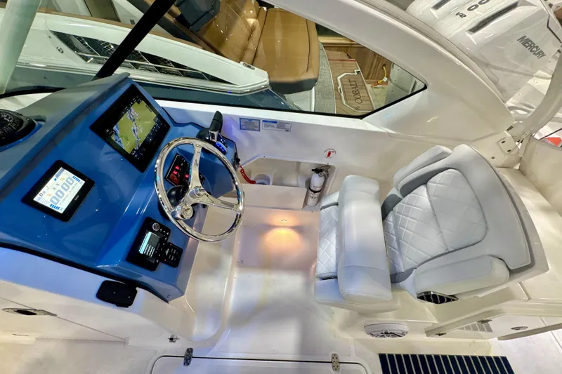  Yacht Photos Pics 2024 Pursuit DC 266 Dual Console boat interior with modern dashboard and luxurious seating.