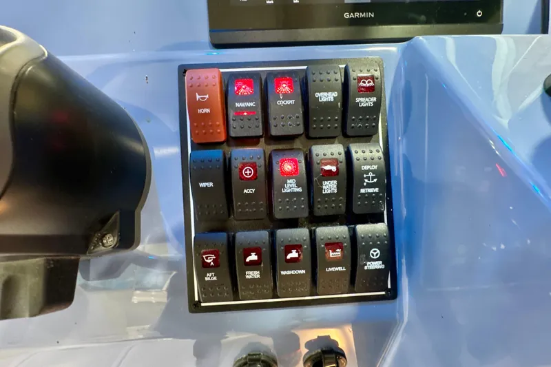  Yacht Photos Pics Control panel of 2024 Pursuit DC 266 Dual Console boat with labeled switches.