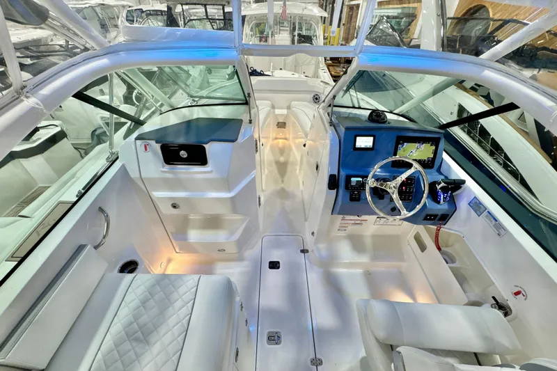  Yacht Photos Pics 2024 Pursuit DC 266 Dual Console boat interior with modern dashboard and seating.