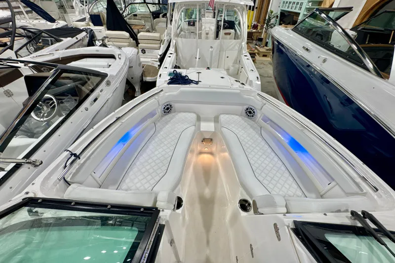  Yacht Photos Pics 2024 Pursuit DC 266 Dual Console boat interior with luxurious seating and ambient lighting.