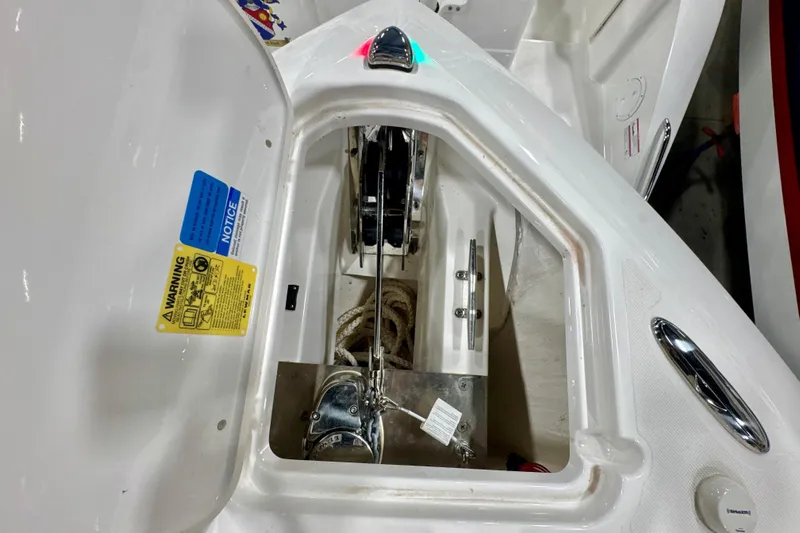  Yacht Photos Pics 2024 Pursuit DC 266 Dual Console anchor compartment with warning labels and rope storage.