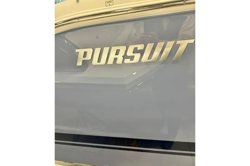  Yacht Photos Pics 2024 Pursuit DC 266 Dual Console boat logo on sleek exterior.