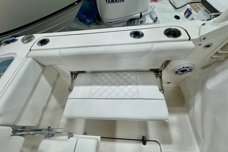  Yacht Photos Pics 2024 Pursuit DC 266 Dual Console boat interior with white seating and cup holders.