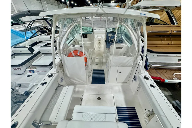  Yacht Photos Pics 2024 Pursuit DC 266 Dual Console boat interior with seating and steering area.