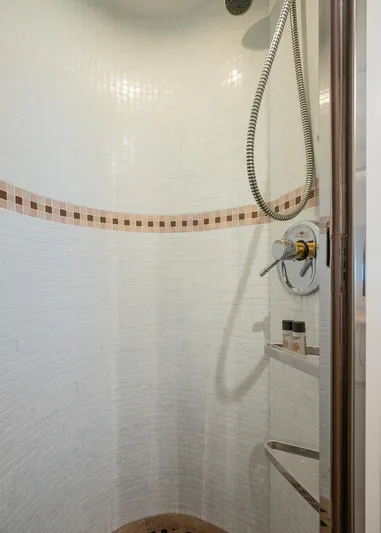  Yacht Photos Pics Shower area in 1996 Mochi Craft 25 Mega yacht with tiled walls and modern fixtures.