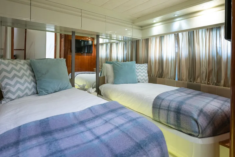  Yacht Photos Pics Twin bedroom in 1996 Mochi Craft 25 Mega yacht with cozy decor and soft lighting.