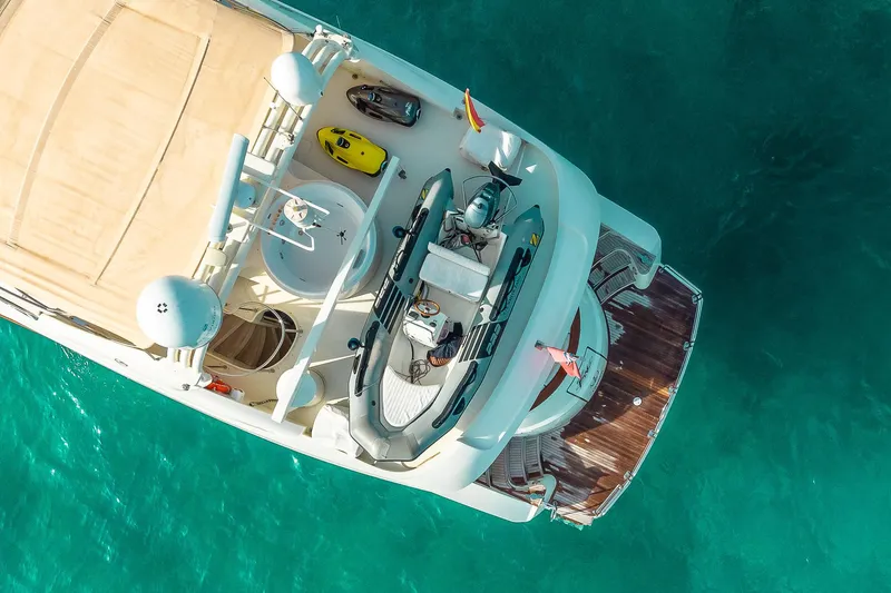  Yacht Photos Pics Aerial view of 1996 Mochi Craft 25 Mega yacht on turquoise water.