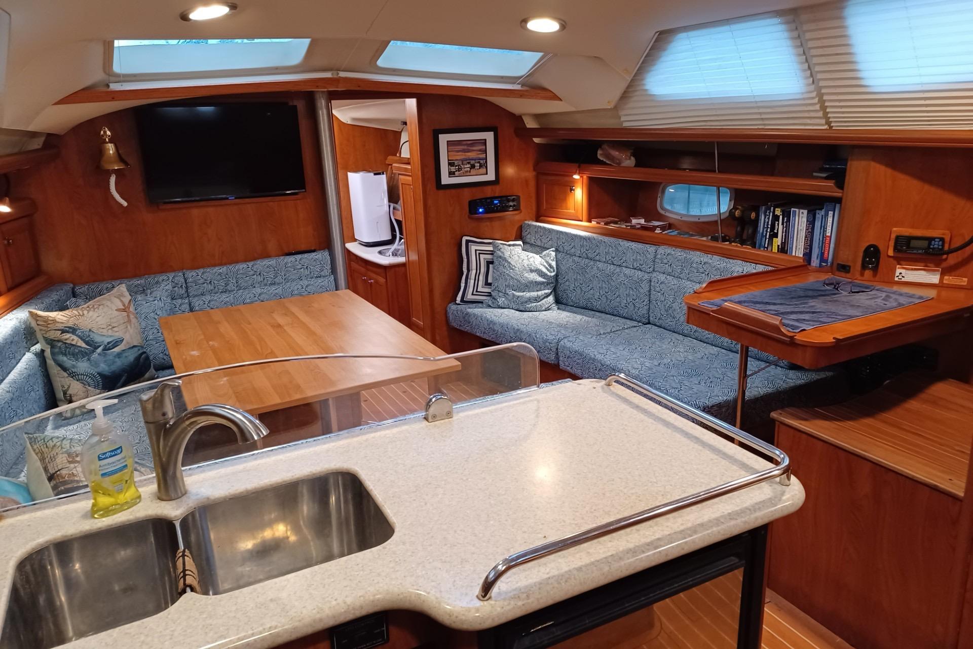 Interior of 2011 Hunter 45 Deck Salon yacht with cozy seating and modern amenities.