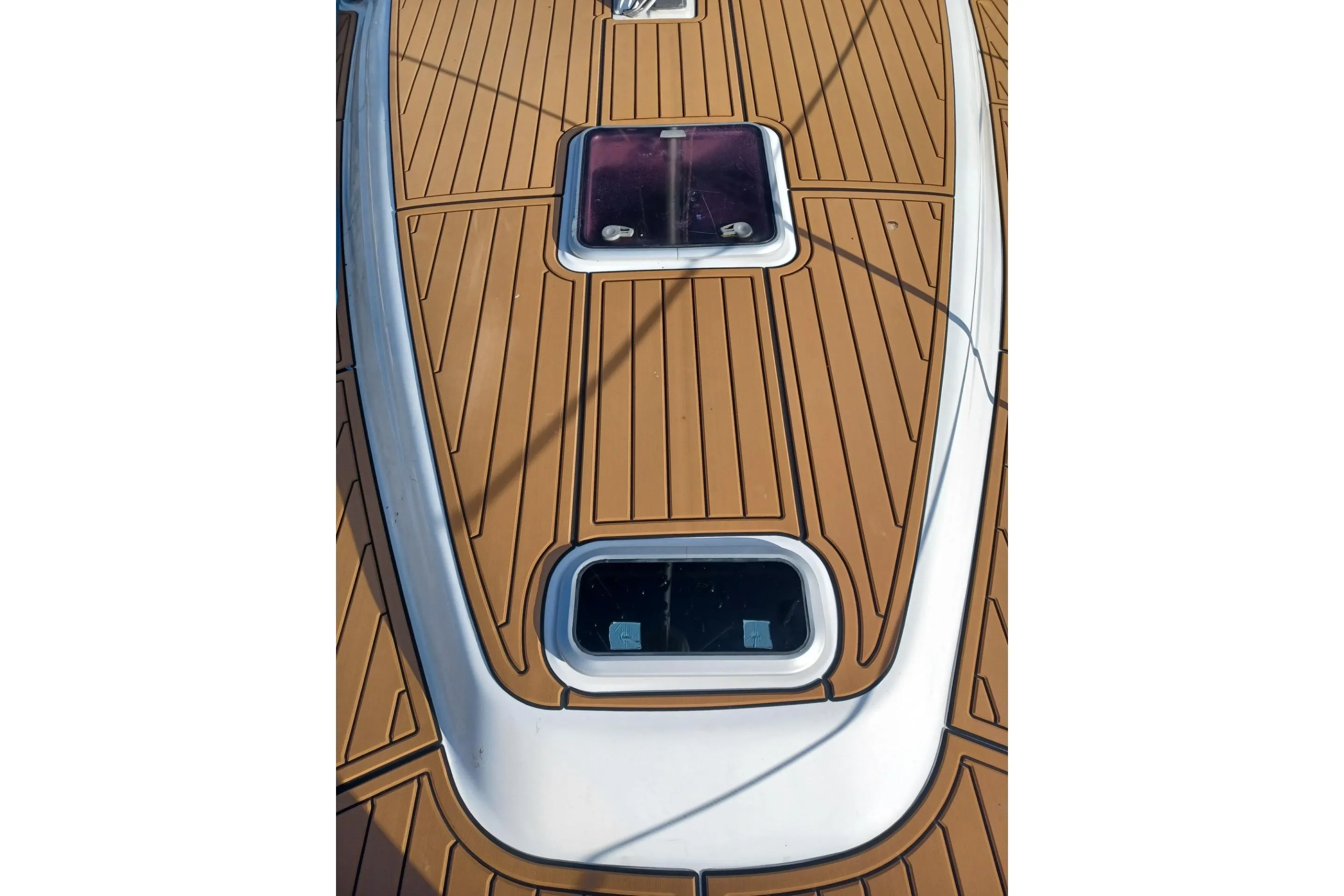 Deck of 2011 Hunter 45 Deck Salon sailboat with wooden finish and hatches.