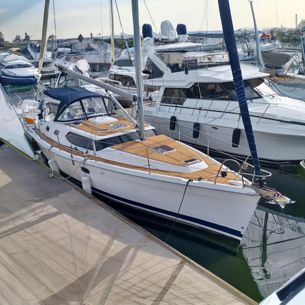 2011 Hunter 45 Deck Salon yacht docked at marina, featuring sleek design and wooden deck.