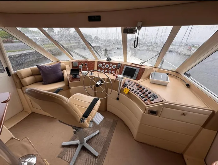  Yacht Photos Pics 2005 Meridian 490 Pilothouse interior with steering wheel, control panel, and leather seating.