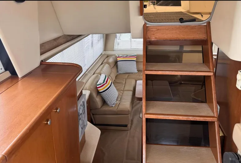  Yacht Photos Pics Interior of 2005 Meridian 490 Pilothouse with wooden stairs and cozy seating area.