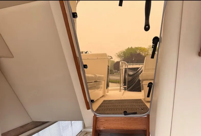  Yacht Photos Pics Interior view of 2005 Meridian 490 Pilothouse yacht, showing stairs and seating area.