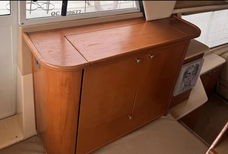  Yacht Photos Pics Wooden cabinet inside 2005 Meridian 490 Pilothouse yacht, featuring sleek design and storage space.