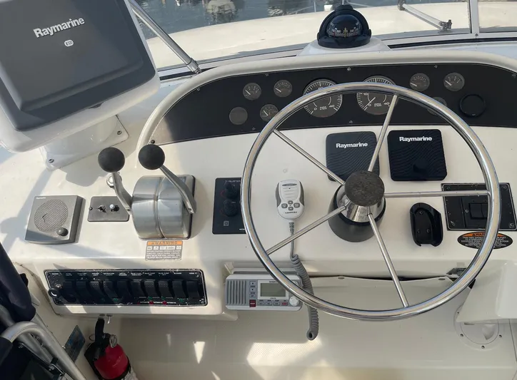  Yacht Photos Pics 2005 Meridian 490 Pilothouse helm with Raymarine electronics and steering wheel.
