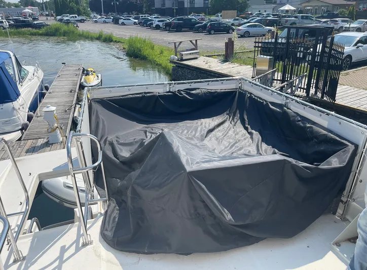  Yacht Photos Pics 2005 Meridian 490 Pilothouse boat docked with covered seating area.