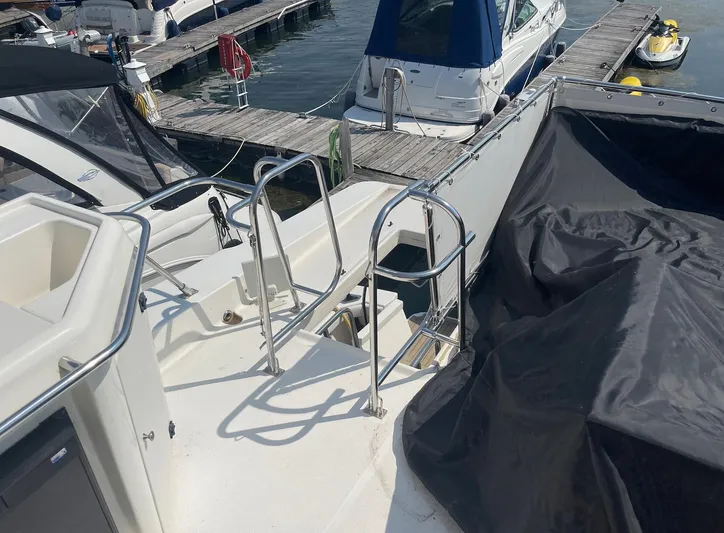  Yacht Photos Pics 2005 Meridian 490 Pilothouse yacht docked, featuring stainless steel railings and covered equipment.